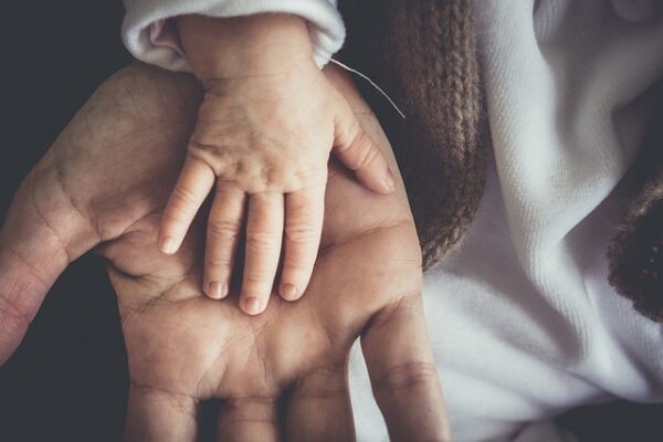 grafika przedstawiające dłoń dziecka i ojca - dzień ojca 2023